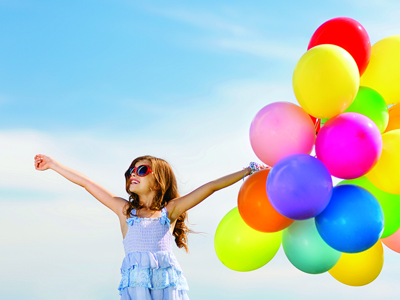 happy girl with colorful balloons
